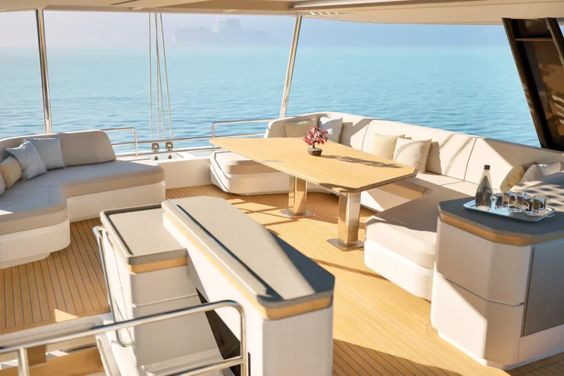 Slide: The Image of Luxurious 2027 Fountaine Pajot 70 S yacht interior with elegant seating and ocean view. - 12