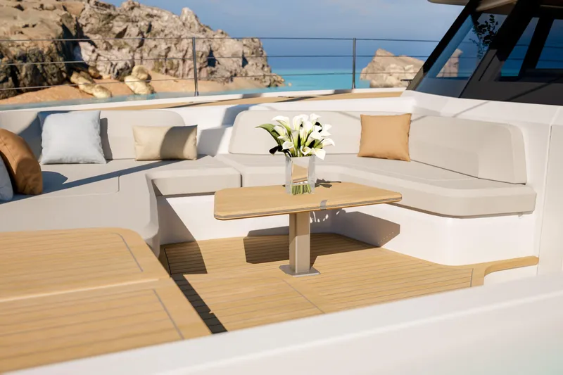 Slide: The Image of Luxurious 2027 Fountaine Pajot 70 S yacht deck with elegant seating and scenic ocean view. - 22