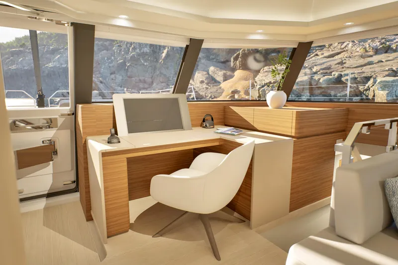Slide: The Image of Luxurious interior of 2027 Fountaine Pajot 70 S yacht with modern desk and seating. - 24