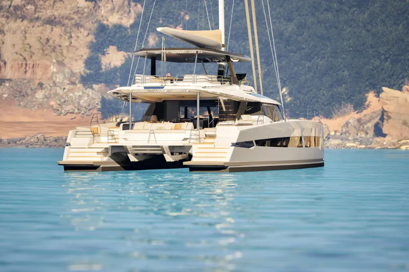 Slide: The Image of Luxurious 2027 Fountaine Pajot 70 S catamaran on serene blue waters. - 3