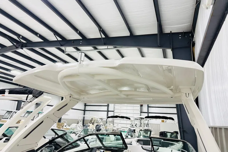 Slide: The Image of 2026 Chaparral 270 OSX boat in showroom, featuring sleek design and modern structure. - 12