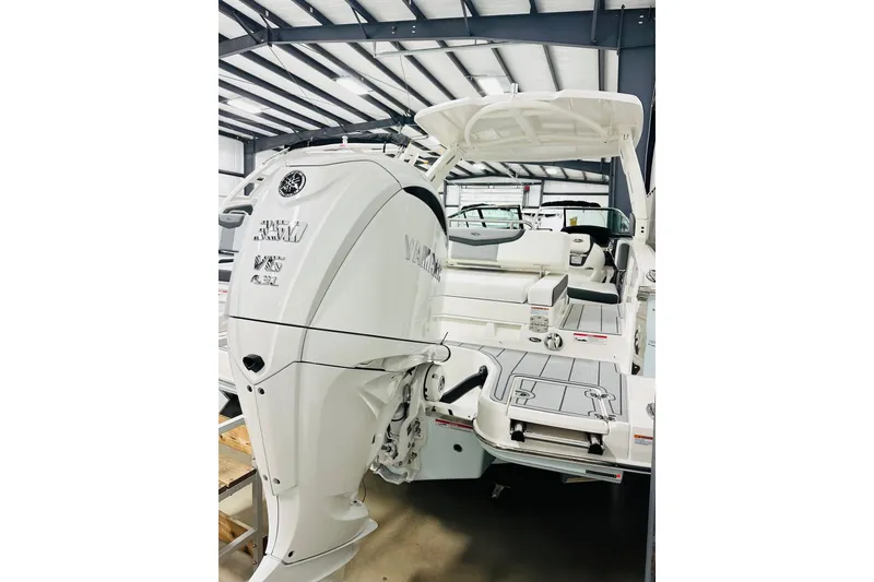 Slide: The Image of 2026 Chaparral 270 OSX boat with Yamaha engine in a showroom. - 13