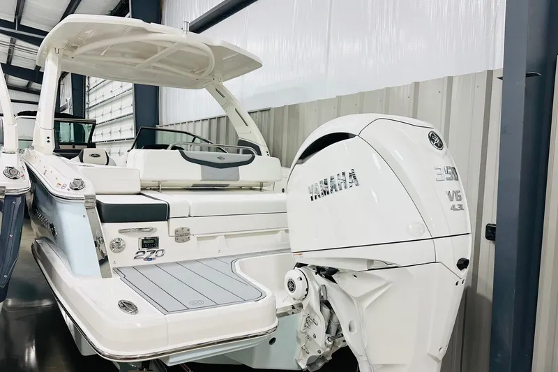 The Image of 2026 Chaparral 270 OSX boat with Yamaha V6 engine in a showroom. - 2