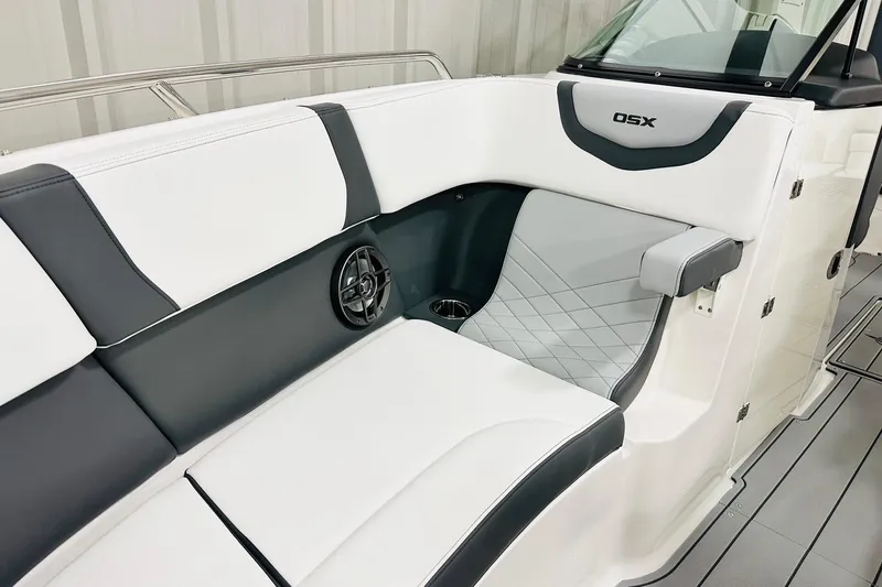 Slide: The Image of 2026 Chaparral 270 OSX boat interior with white and gray seating, speaker, and cup holder. - 8