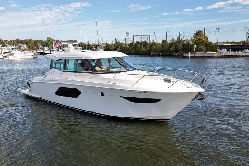 The Image of 2019 Tiara Yachts C49 Coupe cruising on a scenic waterway. - 0