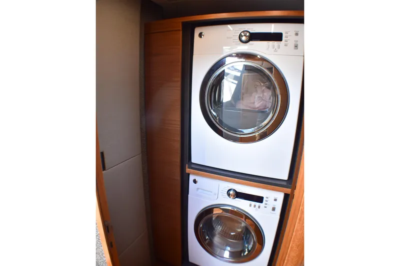 Slide: The Image of Stacked washer and dryer in 2019 Tiara Yachts C49 Coupe interior. - 15