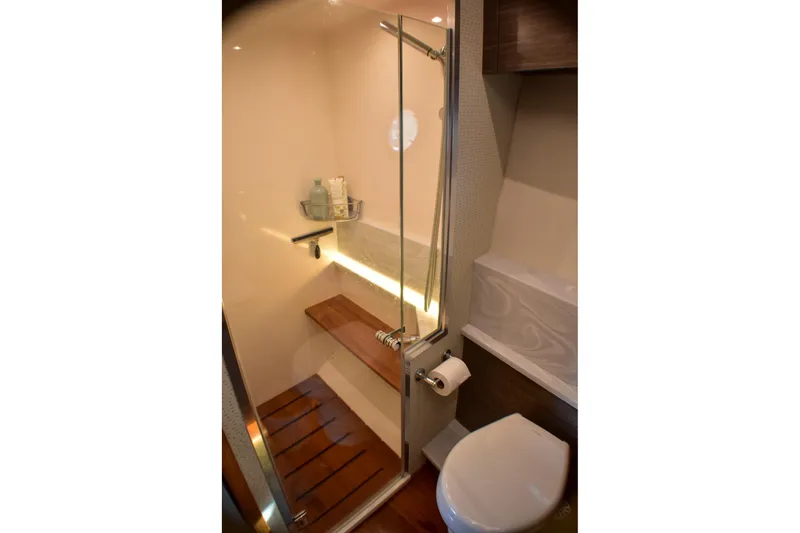 Slide: The Image of Luxurious bathroom in 2019 Tiara Yachts C49 Coupe with modern shower and wooden accents. - 18