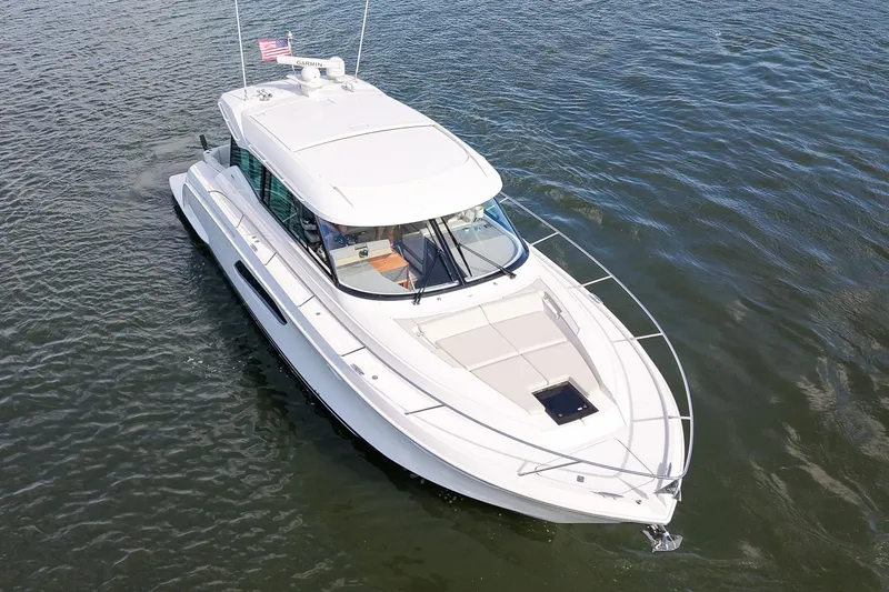 Slide: The Image of 2019 Tiara Yachts C49 Coupe cruising on open water, aerial view. - 2