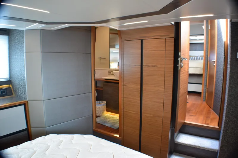 Slide: The Image of 2019 Tiara Yachts C49 Coupe interior with modern wood finishes and cozy bedroom. - 21