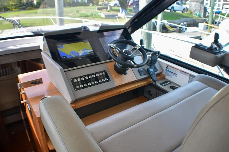 Slide: The Image of 2019 Tiara Yachts C49 Coupe helm with navigation display and controls. - 22