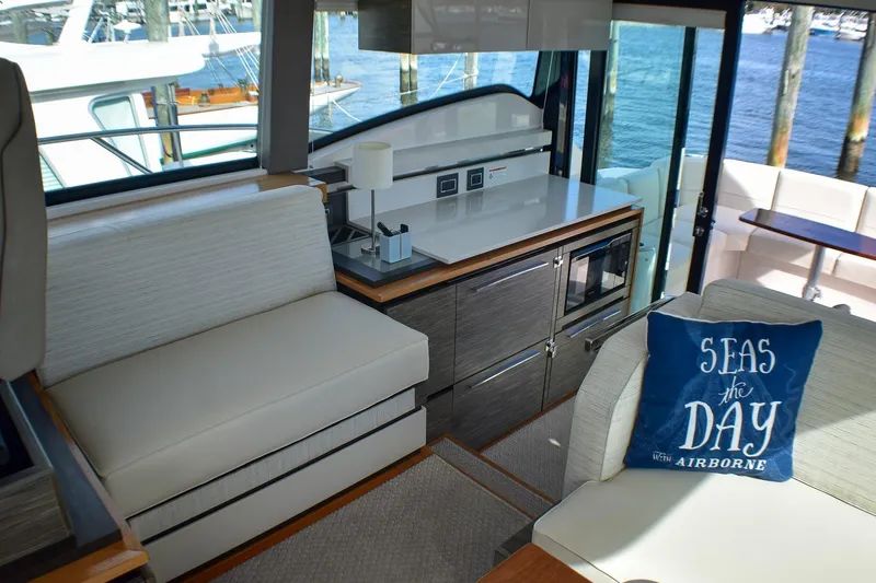 Slide: The Image of 2019 Tiara Yachts C49 Coupe interior with modern seating and nautical decor. - 23