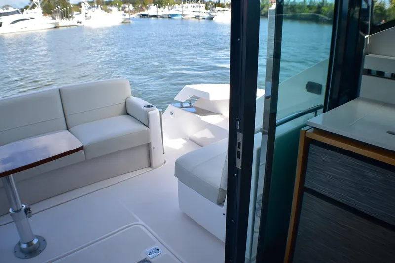 Slide: The Image of 2019 Tiara Yachts C49 Coupe interior with elegant seating and scenic water view. - 30