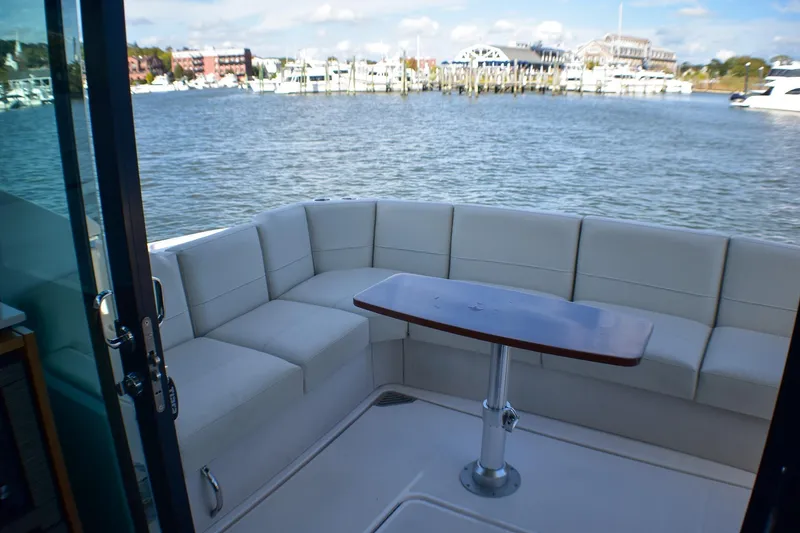 Slide: The Image of 2019 Tiara Yachts C49 Coupe with elegant seating and scenic waterfront view. - 31