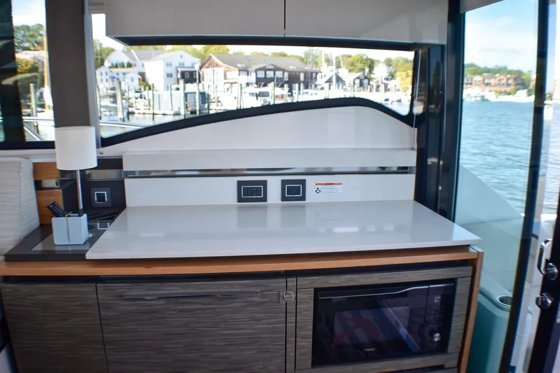 Slide: The Image of Interior of 2019 Tiara Yachts C49 Coupe with modern kitchen amenities. - 32