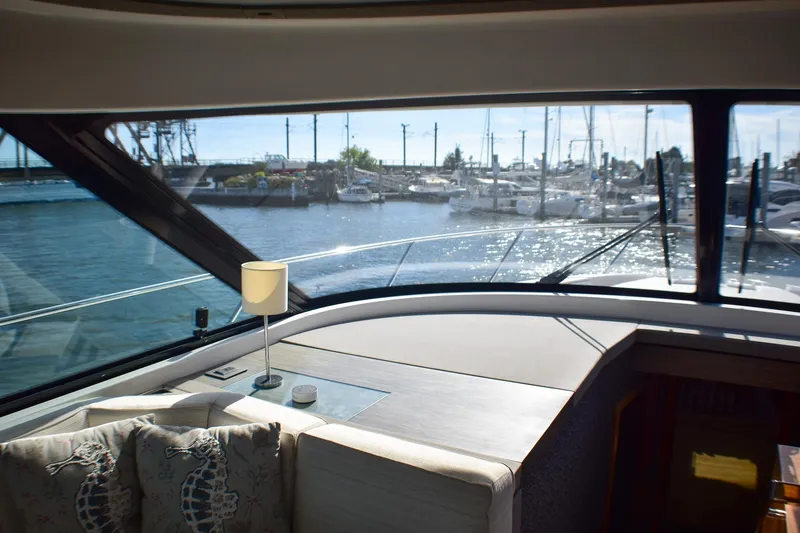 Slide: The Image of Interior view of 2019 Tiara Yachts C49 Coupe with marina backdrop. - 33
