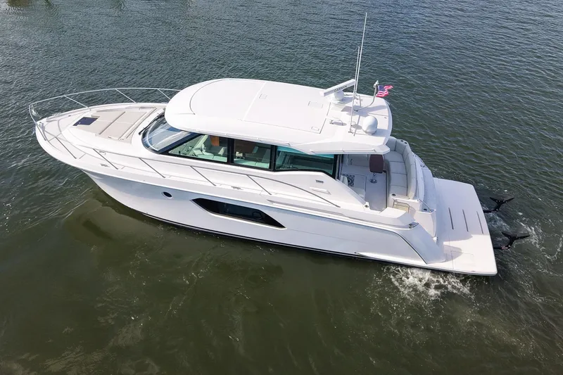 Slide: The Image of 2019 Tiara Yachts C49 Coupe cruising on water, sleek design, luxury motor yacht. - 5