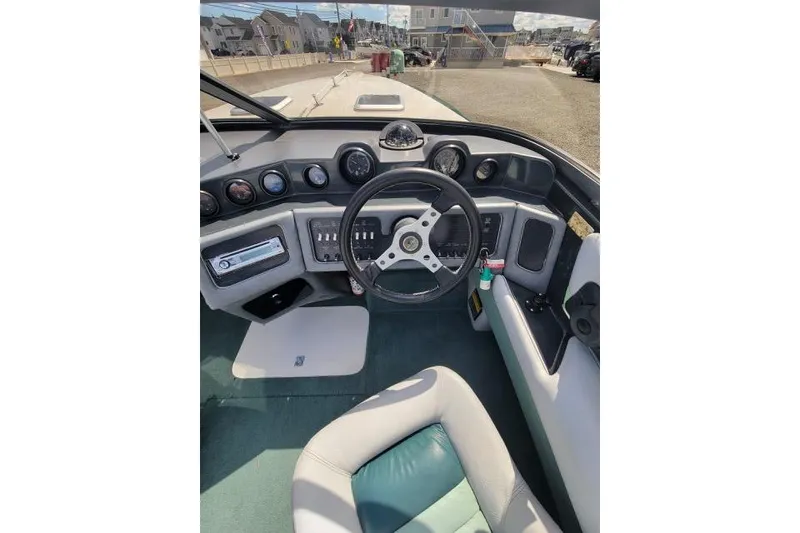 Slide: The Image of 1987 Searay Pachanga boat cockpit with steering wheel and dashboard controls. - 6