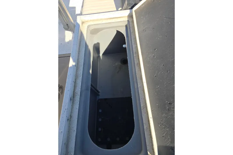 Slide: The Image of Open storage compartment on 2015 G3 Bay 18 DLX boat, showing interior details. - 11