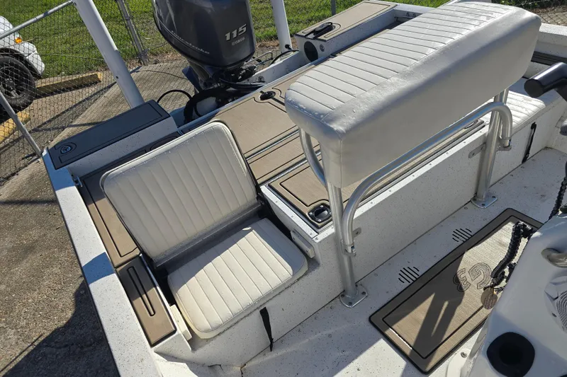 Slide: The Image of 2015 G3 Bay 18 DLX boat interior with seating and Yamaha 115 engine. - 12