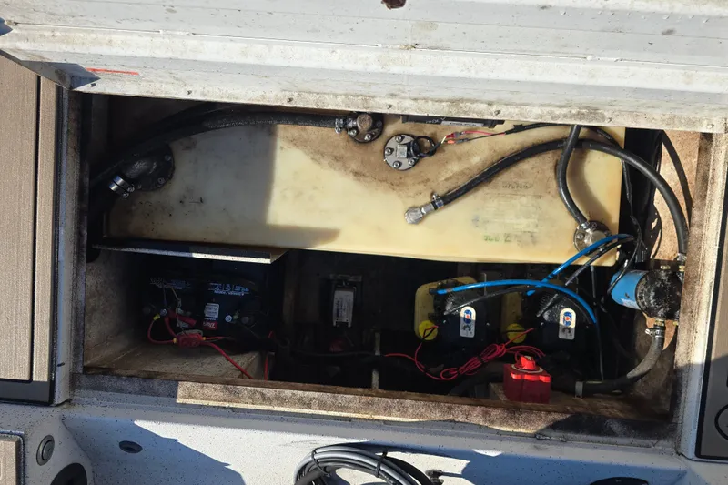 Slide: The Image of 2015 G3 Bay 18 DLX boat compartment with wiring and fuel system components. - 13