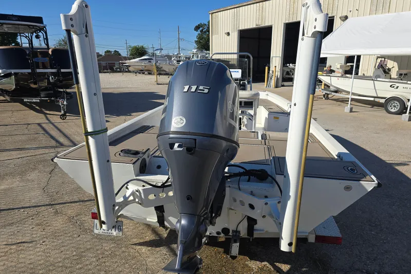Slide: The Image of 2015 G3 Bay 18 DLX boat with Yamaha 115 outboard motor, parked outdoors. - 3