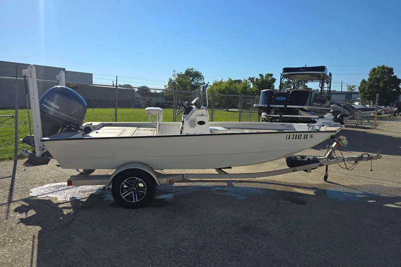 Slide: The Image of 2015 G3 Bay 18 DLX boat on trailer with Yamaha outboard motor, parked outdoors. - 5