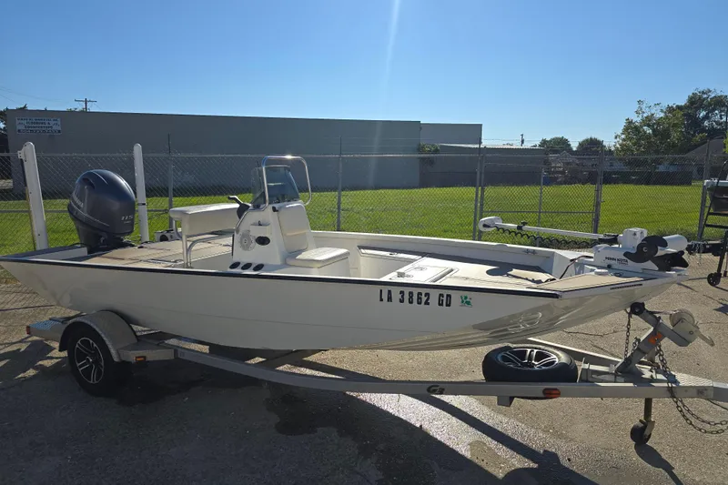 Slide: The Image of 2015 G3 Bay 18 DLX boat on trailer, parked outdoors in sunny setting. - 6