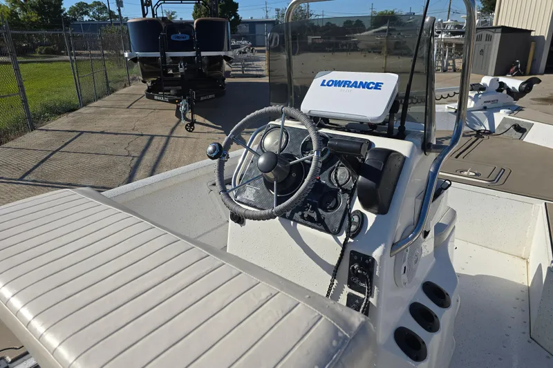 Slide: The Image of 2015 G3 Bay 18 DLX boat interior with steering wheel and Lowrance device. - 9