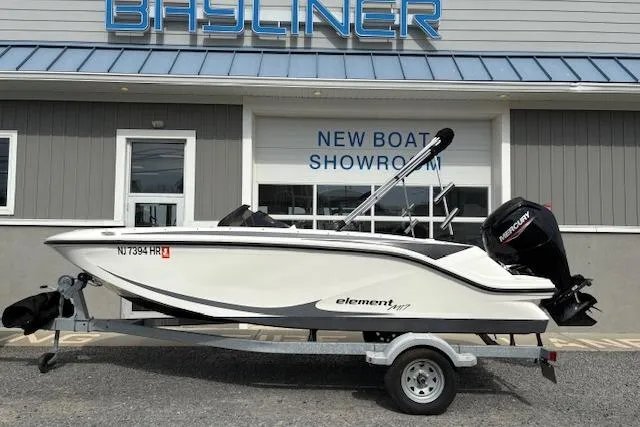 Slide: The Image of 2022 Bayliner Element M17 boat on trailer outside showroom. - 1