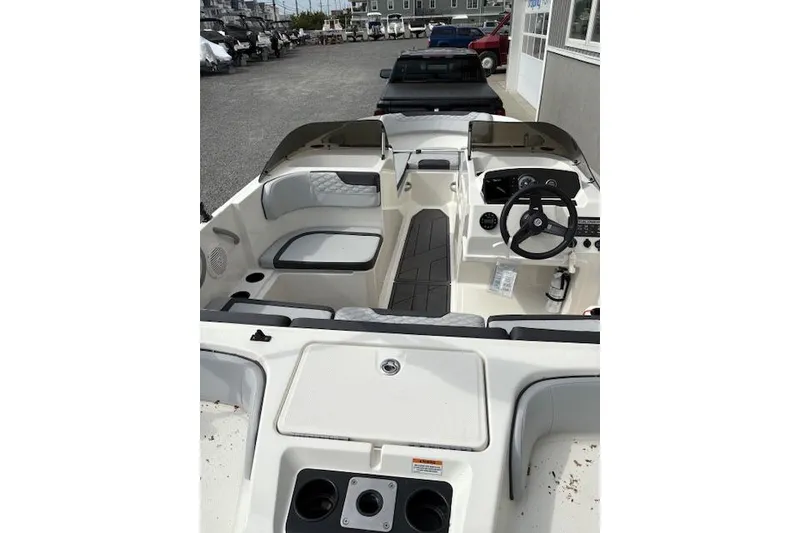 Slide: The Image of 2022 Bayliner Element M17 boat interior with seating and steering wheel. - 2