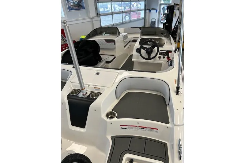 Slide: The Image of 2022 Bayliner Element M17 boat interior with steering wheel and seating area. - 4