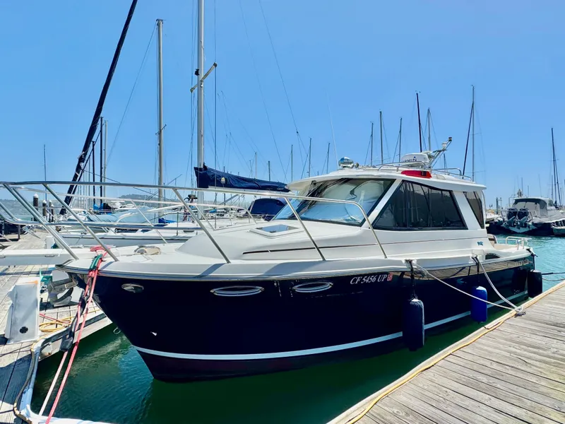 Slide: The Image of 2015 Cutwater C26 boat docked at marina under clear blue sky. - 0