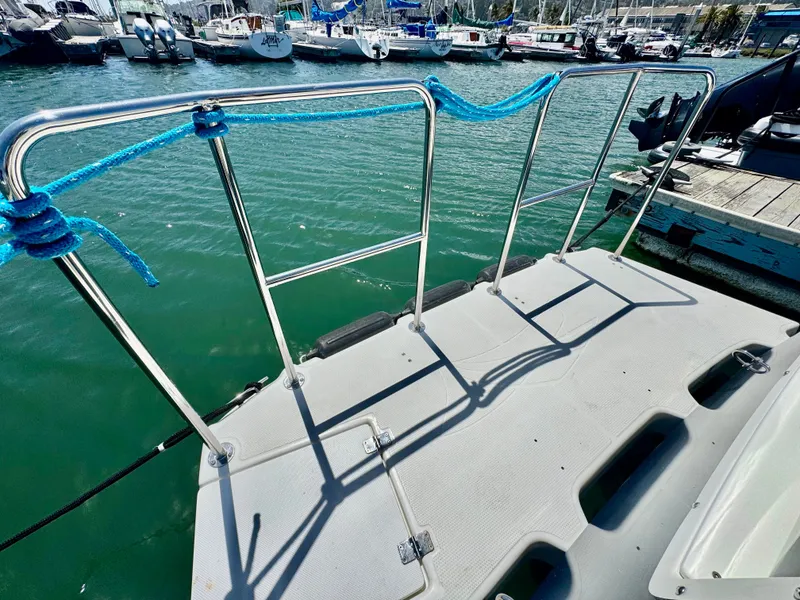 Slide: The Image of 2015 Cutwater C26 boat deck with blue rope railing at marina. - 10