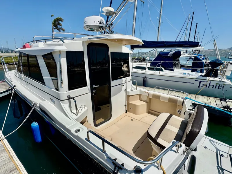 Slide: The Image of 2015 Cutwater C26 boat docked at marina, featuring spacious deck and modern design. - 11