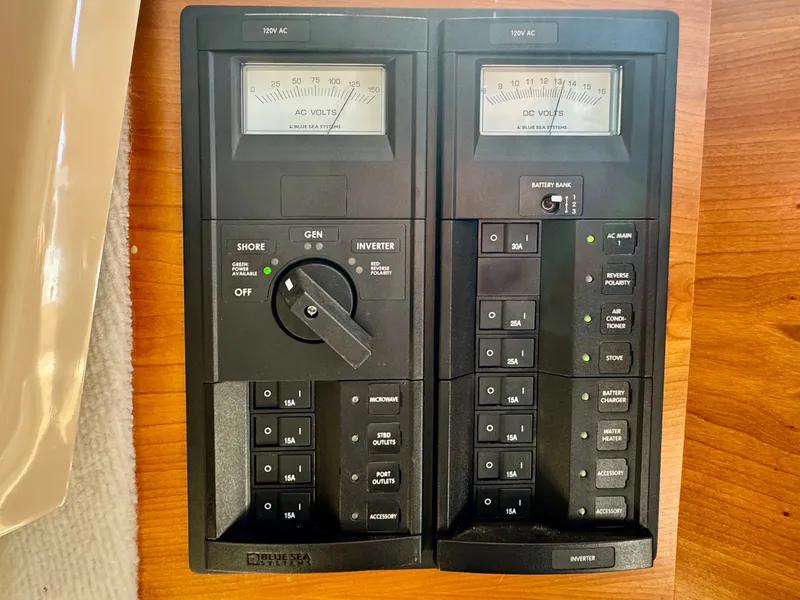 Slide: The Image of Electrical control panel on a 2015 Cutwater C26 boat, featuring AC and DC volt meters. - 23