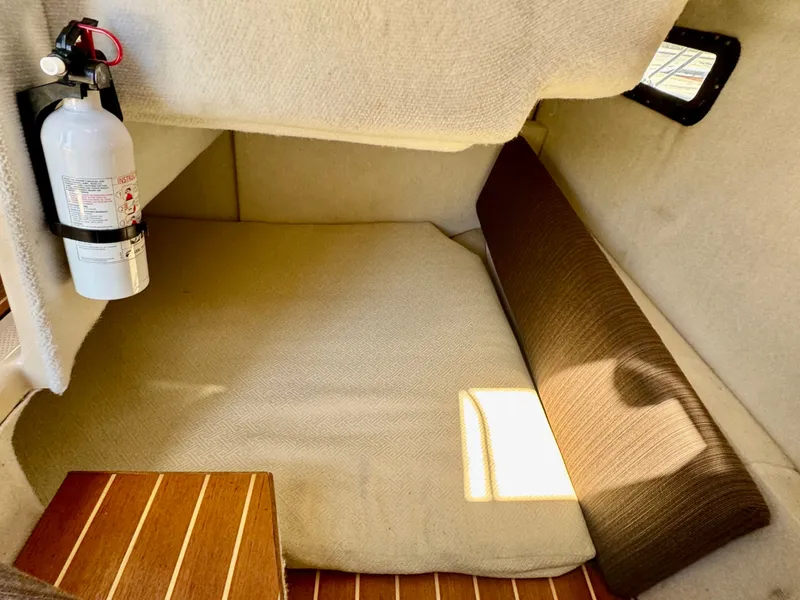 Slide: The Image of 2015 Cutwater C26 cabin interior with fire extinguisher and cushioned seating. - 24
