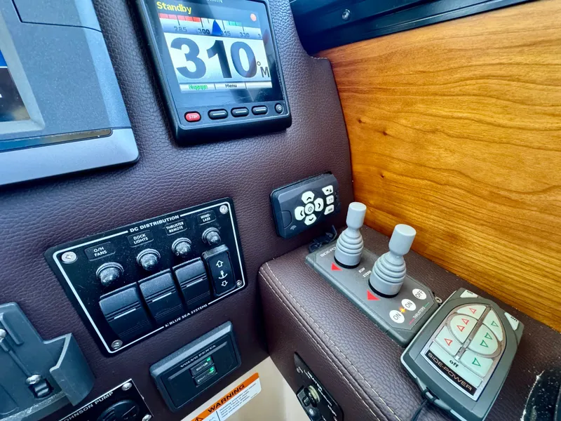 Slide: The Image of Control panel of a 2015 Cutwater C26 boat with navigation and joystick controls. - 33