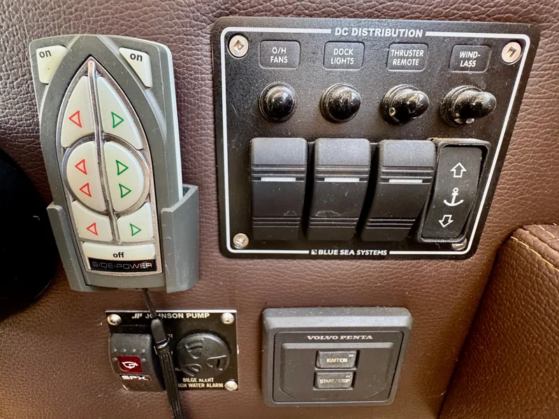 Slide: The Image of Control panel of a 2015 Cutwater C26 boat with various switches and buttons. - 34