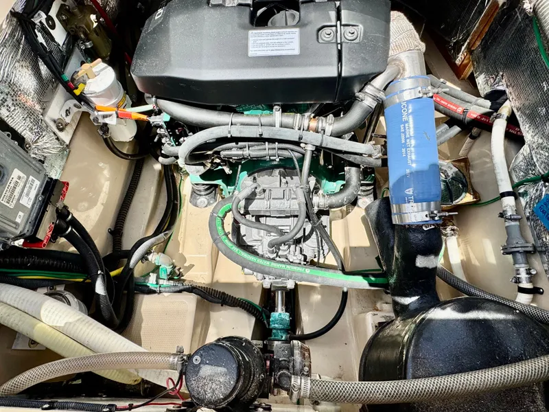 Slide: The Image of Engine compartment of a 2015 Cutwater C26 boat, showcasing detailed mechanical components. - 49