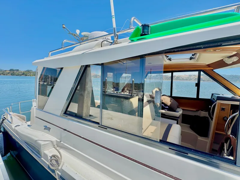 Slide: The Image of 2015 Cutwater C26 boat docked, showcasing sleek design and spacious interior. - 5