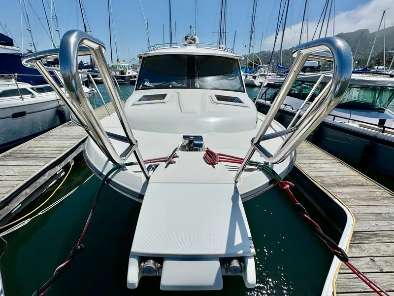 Slide: The Image of 2015 Cutwater C26 boat docked at marina, surrounded by other vessels. - 7