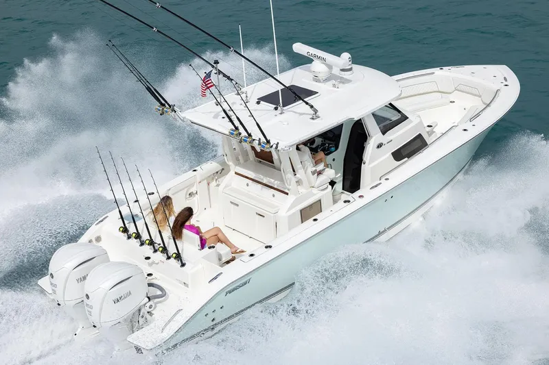Slide: The Image of Manufacturer Provided Image: 2025 Pursuit S 328 Sport boat cruising on water with fishing rods. - 4
