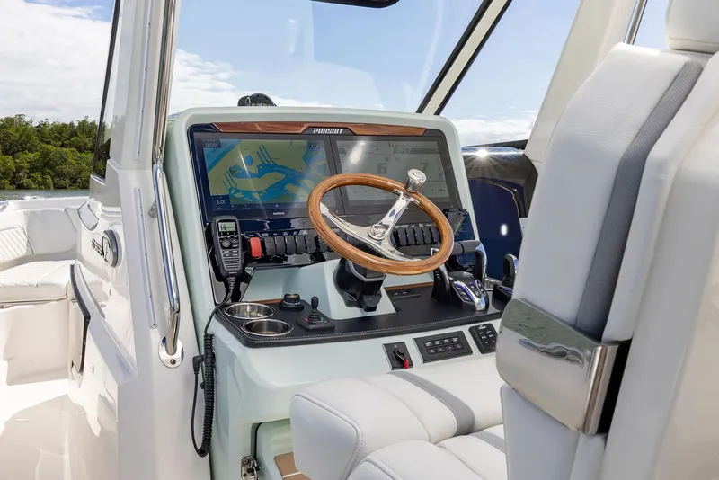 Slide: The Image of Manufacturer Provided Image: 2025 Pursuit S 328 Sport boat cockpit with modern navigation system and wooden steering wheel. - 9