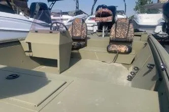 Slide: The Image of 2019 Lowe Roughneck 1860CC boat with camo seats and spacious deck. - 3