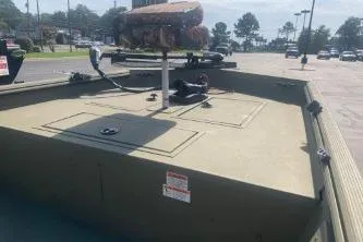 Slide: The Image of 2019 Lowe Roughneck 1860CC boat in a parking lot under sunny skies. - 6