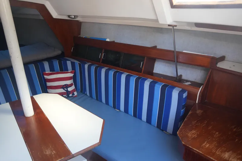 Slide: The Image of Interior of 1986 Hunter 28.5 sailboat with striped seating and nautical decor. - 12