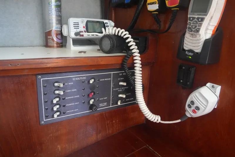 Slide: The Image of Electrical panel and communication devices inside a 1986 Hunter 28.5 sailboat cabin. - 15
