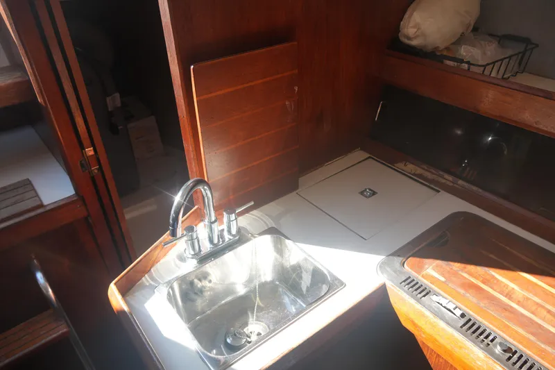 Slide: The Image of Interior of 1986 Hunter 28.5 sailboat galley with sink and wooden cabinetry. - 17