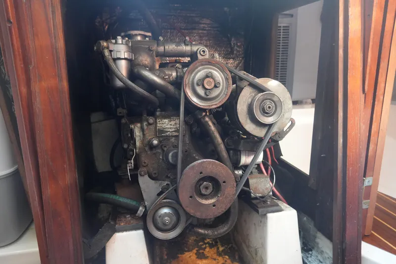 Slide: The Image of 1986 Hunter 28.5 sailboat engine compartment with visible belts and components. - 24