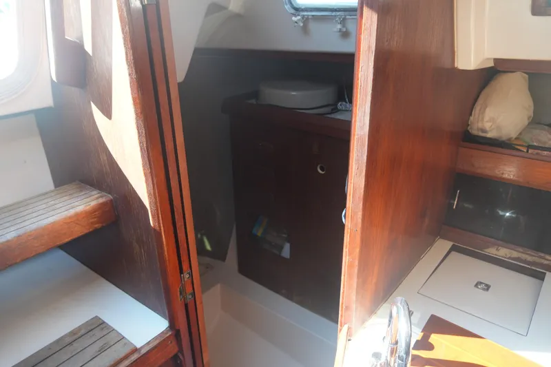 Slide: The Image of Interior of 1986 Hunter 28.5 sailboat with wooden cabinetry and steps. - 25